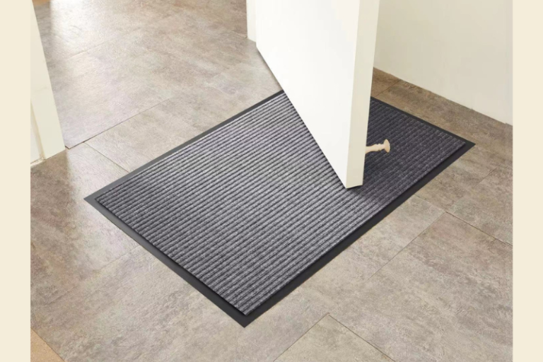 A 3mm low-profile printed rubber doormat lying flat under a residential door without blocking.